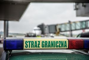Kogut Straż Graniczna na dachu samochodu. W tle samolot. Kogut Straż Graniczna na dachu samochodu. W tle samolot.