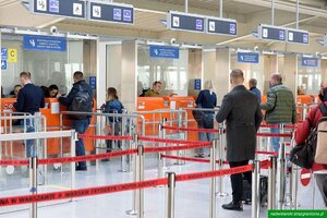 Podróżni stoją przed kabinami kontrolerskimi. Podróżni stoją przed kabinami kontrolerskimi.