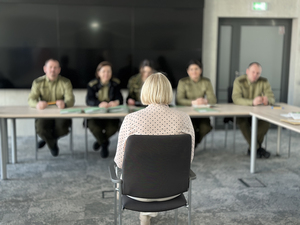 Komisja rekrutacyjna słucha kandydatki siedzącej na krześle. Komisja rekrutacyjna słucha kandydatki siedzącej na krześle.